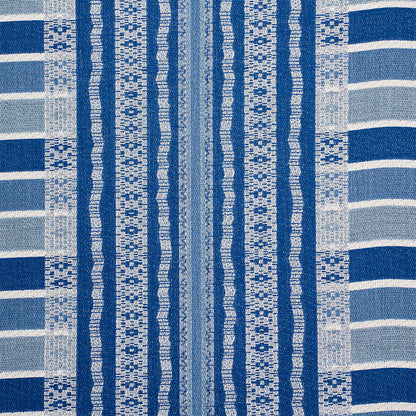 Blue and white woven textile with vertical striped bands and geometric motifs, beach towel style.