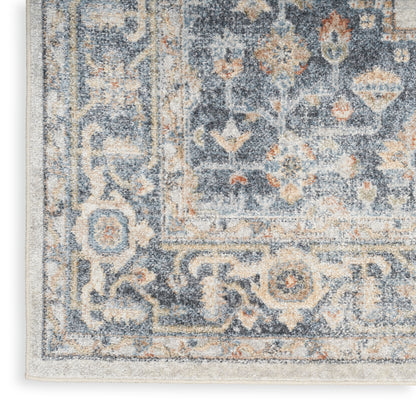 Close-up of a blue and beige Persian-style rug (4' x 6') with an ornate floral border and distressed pile.
