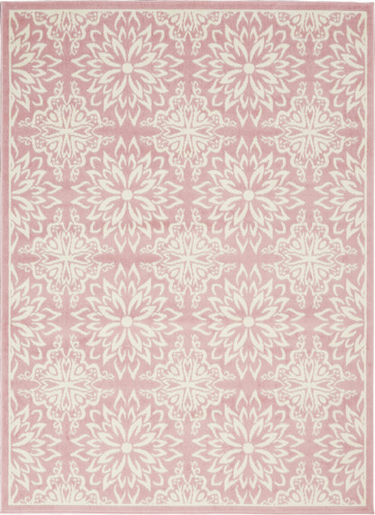 Soft pink area rug with ivory floral medallions, repeating starburst rosettes and pale border trim.
