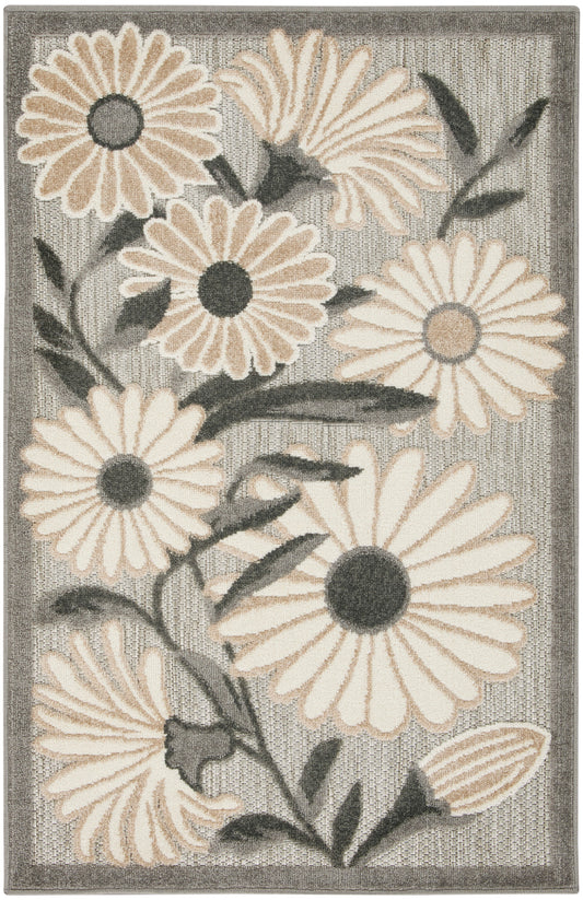 Beige and gray floral area rug with large daisy-like blossoms, dark centers, and a textured bordered weave.