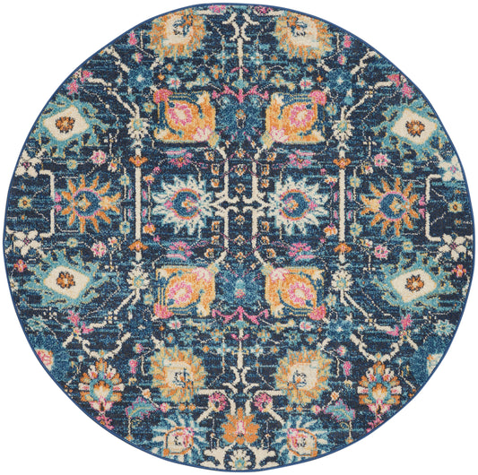 Round oriental-inspired rug with navy background and vibrant teal, orange, pink and cream floral motifs.