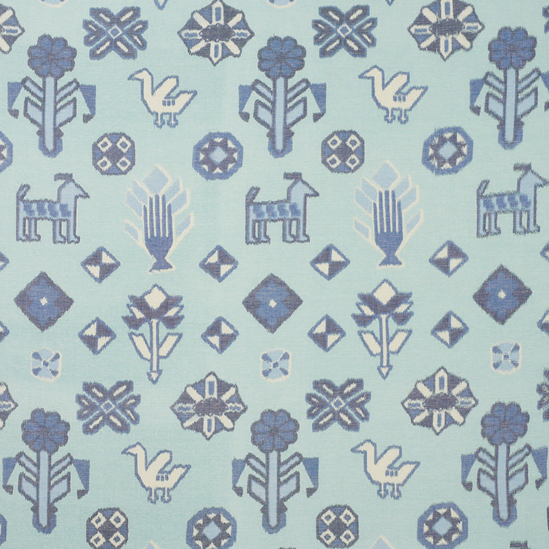 Light blue fabric with Nordic-inspired print in blue hues: birds, goats, trees, diamonds and floral motifs.