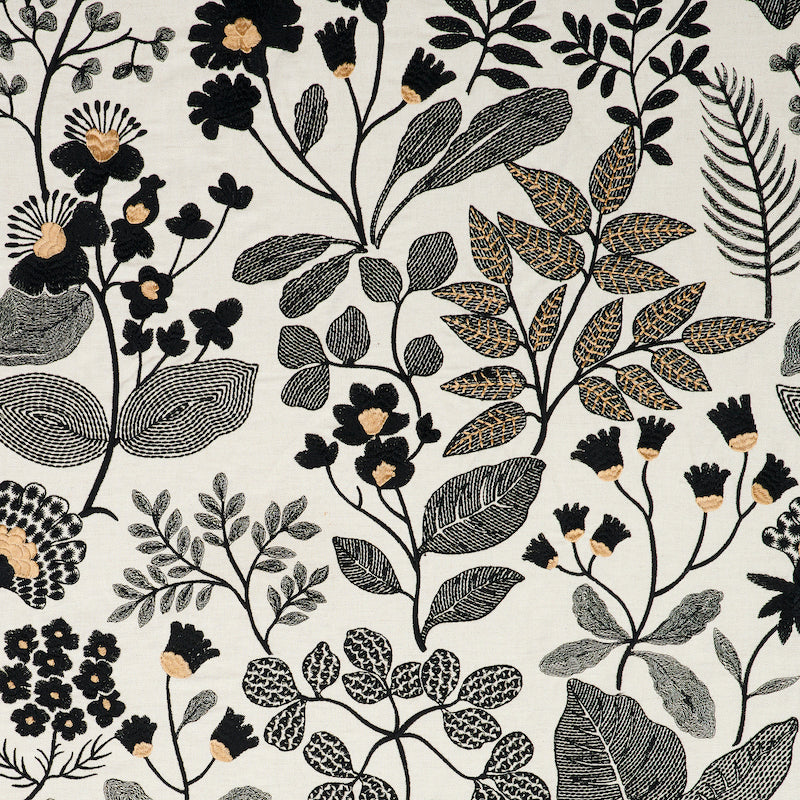Botanical textile pattern with black, gray and beige leaves and small beige flowers on a light cream background.