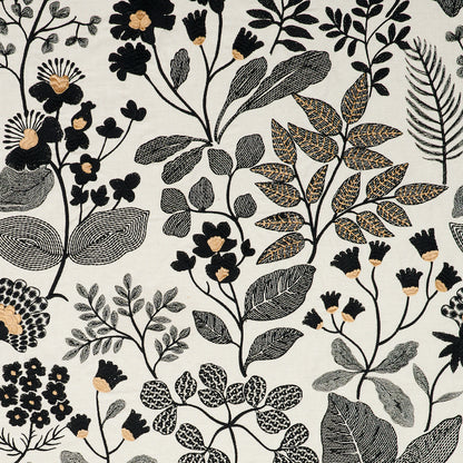 Botanical textile pattern with black, gray and beige leaves and small beige flowers on a light cream background.