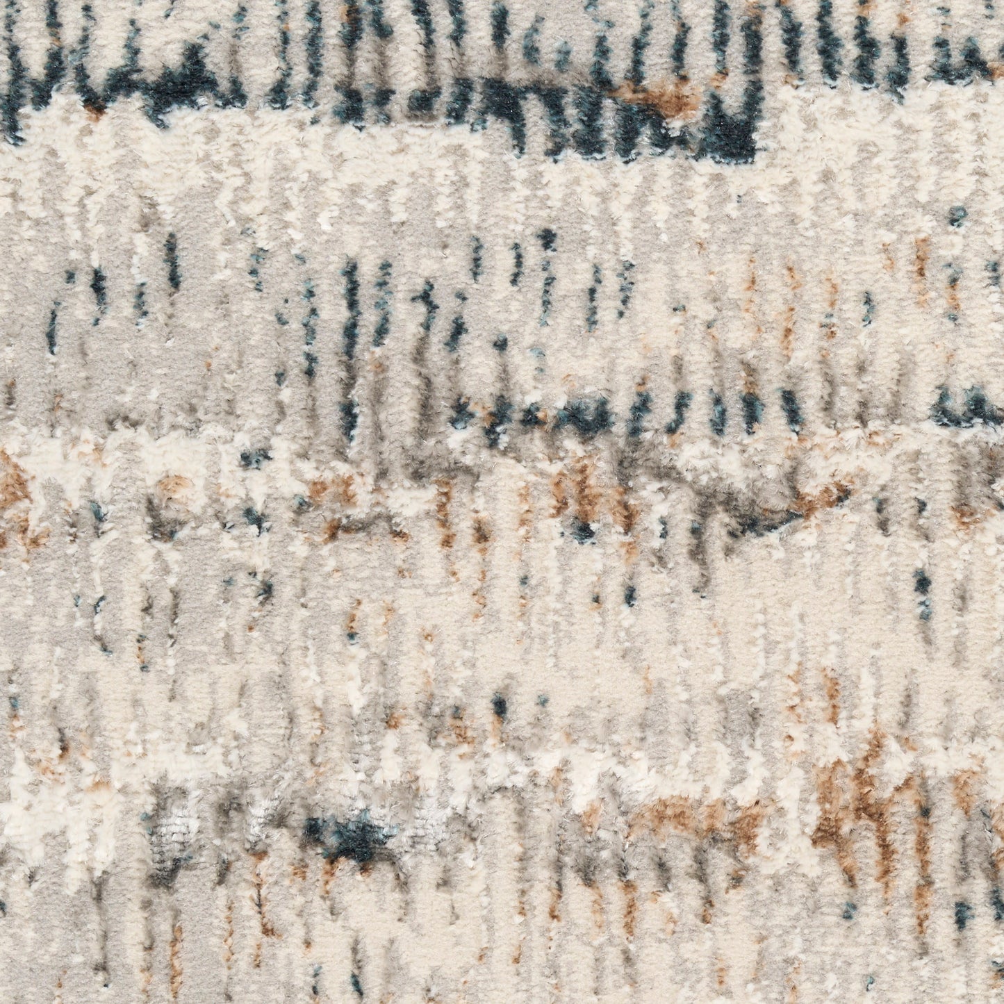 Soft beige shag rug with abstract blue and rust streaks; plush, textured pile.
