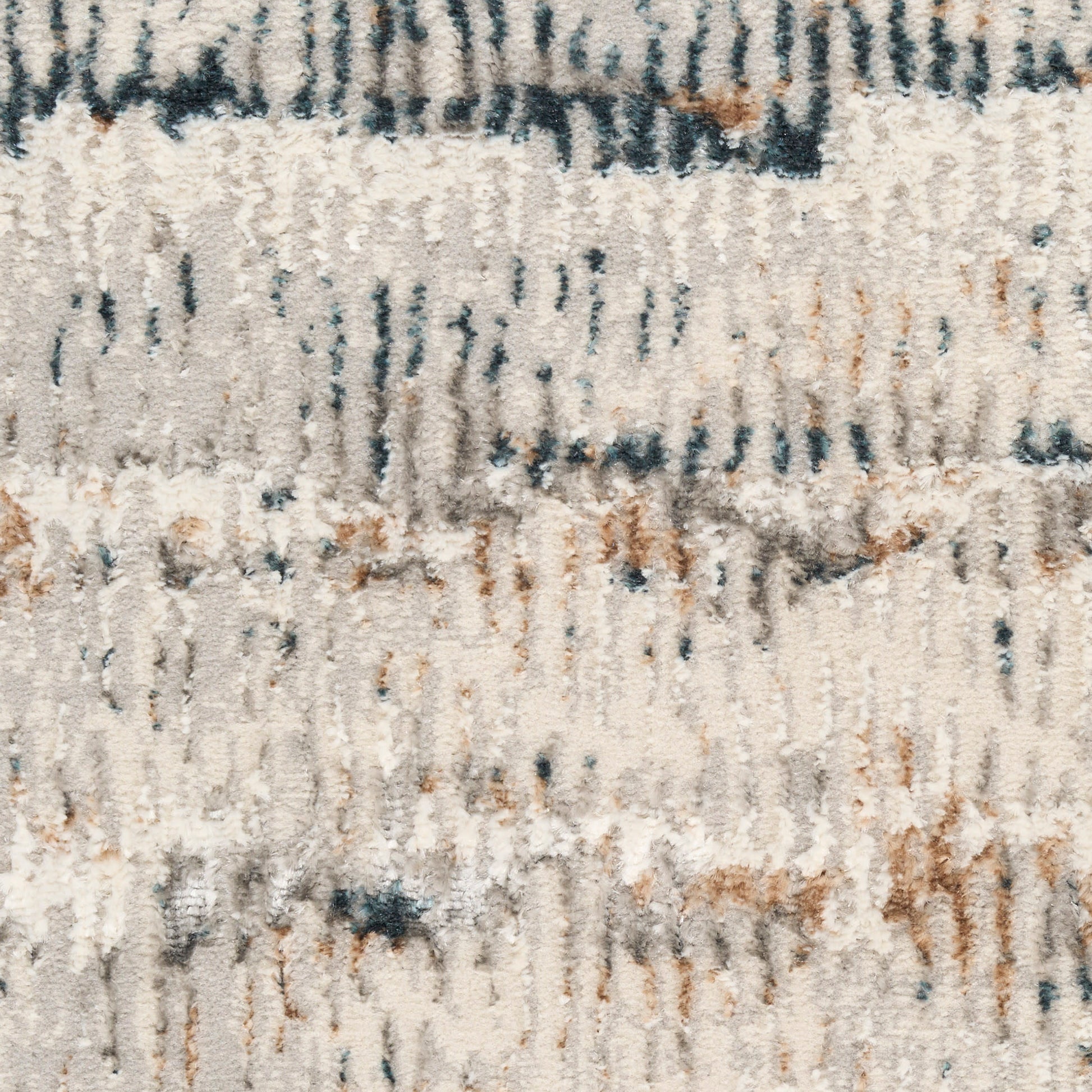 Soft beige shag rug with abstract blue and rust streaks; plush, textured pile.