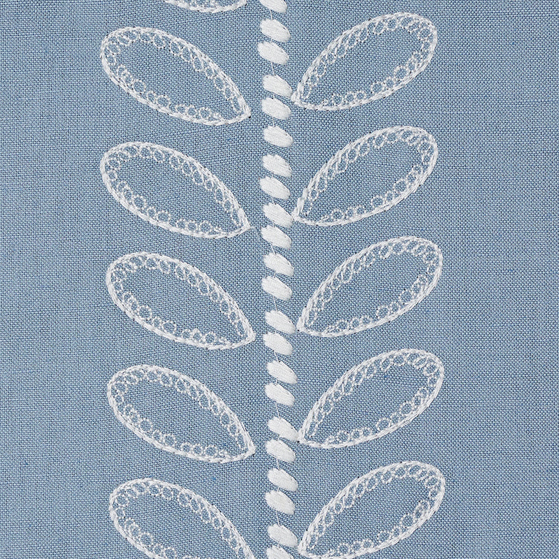 Blue fabric featuring white embroidered leaf motifs arranged along a central vertical line; delicate lace-like stitching.