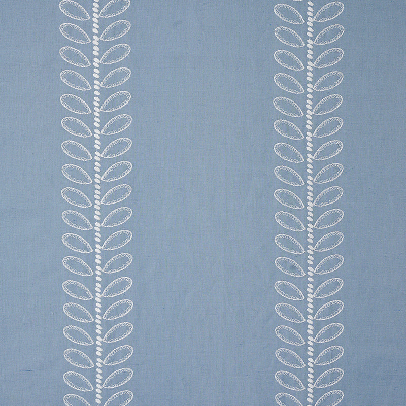 Blue fabric with two vertical white embroidered leaf-patterns along the sides.
