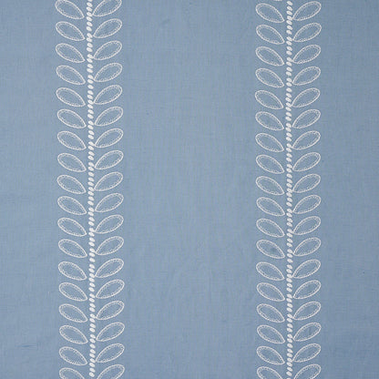 Blue fabric with two vertical white embroidered leaf-patterns along the sides.
