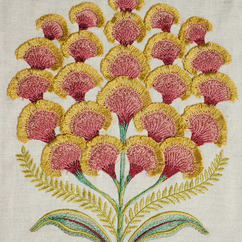 Embroidered pink and yellow mimosa blossoms on cream linen with green stems and fern leaves.