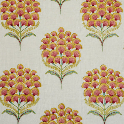 Repeating botanical pattern of pink and yellow pom-pom flowers on green stems with yellow fronds on a cream background.