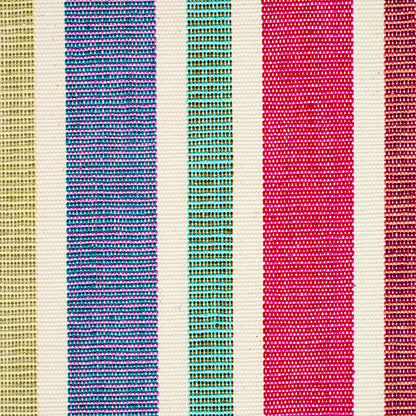 Woven textile with cream base and vertical stripes in gold, blue, teal, pink, magenta and brown; versatile decorative throw.