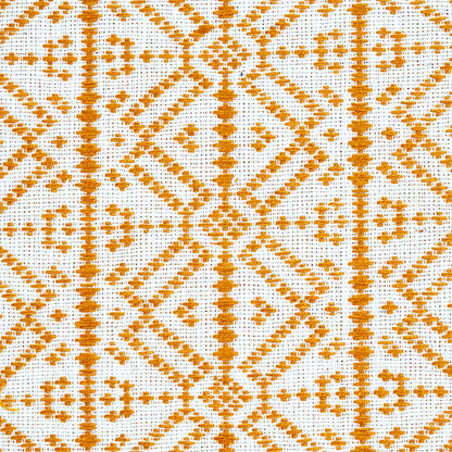 Orange geometric embroidery on white fabric with diamond and line motifs; decorative textile.
