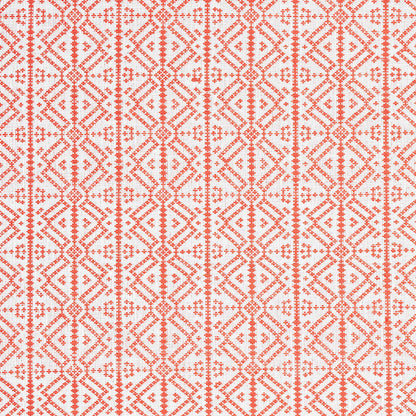 Coral geometric lattice embroidery on white fabric, diamond motifs with dotted lines, ethnic-style textile for home decor.