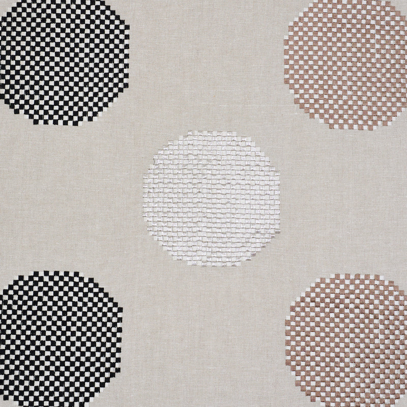 Beige linen-like rug with large circular checkered motifs in black, white, taupe and brown.
