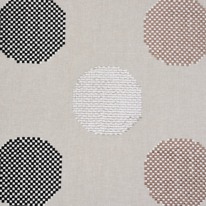 Beige linen-like rug with large circular checkered motifs in black, white, taupe and brown.