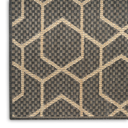 Charcoal rug with tan geometric diamond lattice pattern; textured woven surface for a modern, sophisticated look.