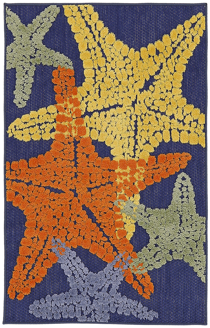 Navy tufted rug with large textured starfish motifs in orange, yellow, sage green, lavender and blue.