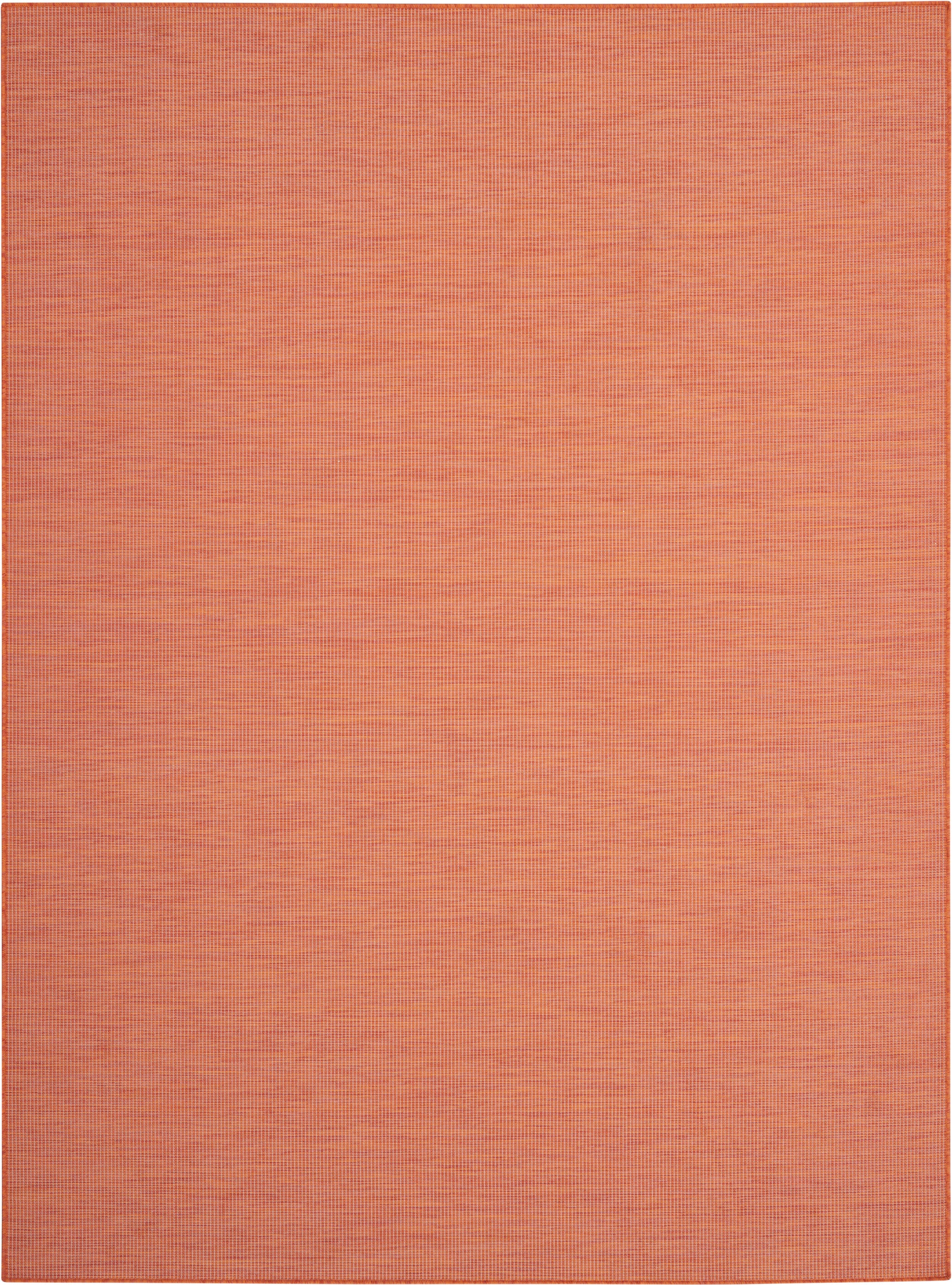 Orange woven rug with subtle grid texture in warm terracotta tones.