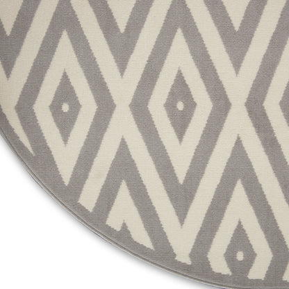 Circular rug with gray and ivory diamond geometric pattern and a soft, textured pile.