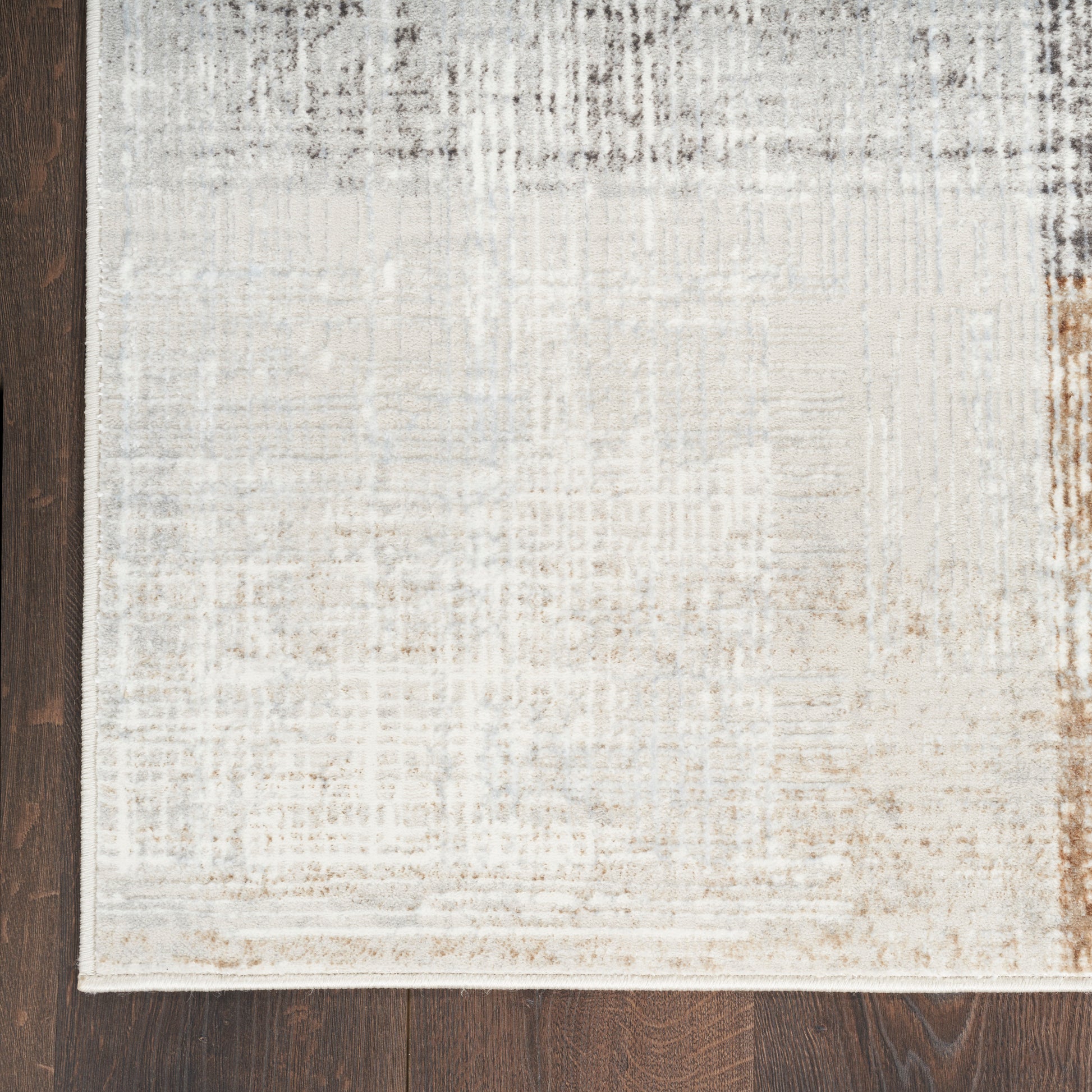 Rectangular area rug in cream, beige and taupe with subtle distressed texture; modern soft low-pile.