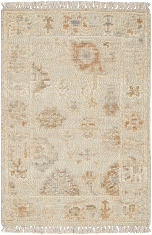 Cream-colored oriental rug with subtle floral-geometric motifs in beige, taupe and peach; fringed ends.