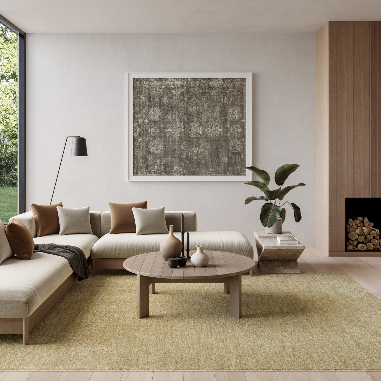 Beige sectional sofa with round wood coffee table, abstract gray art, black floor lamp, plant by fireplace, yellow rug.
