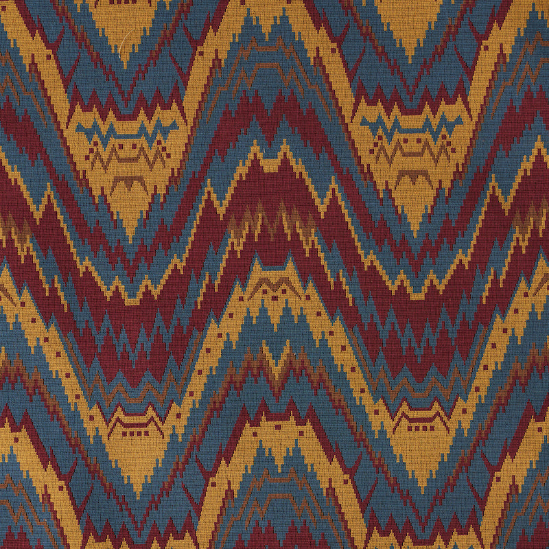 Kilim-inspired woven rug pattern with navy, teal, mustard and burgundy zigzag chevrons.
