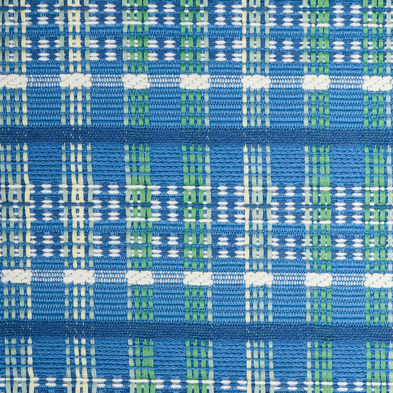 Close-up of blue woven fabric with white and green plaid checks, textured interlaced threads.