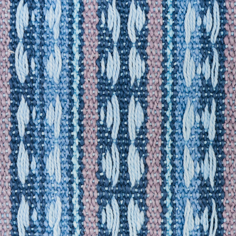 Close-up of a blue-toned striped woven fabric; textured weave with visible fibers.