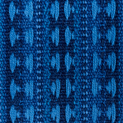 Close-up of indigo woven fabric with Tarnby stripe pattern; textured jacquard weave.