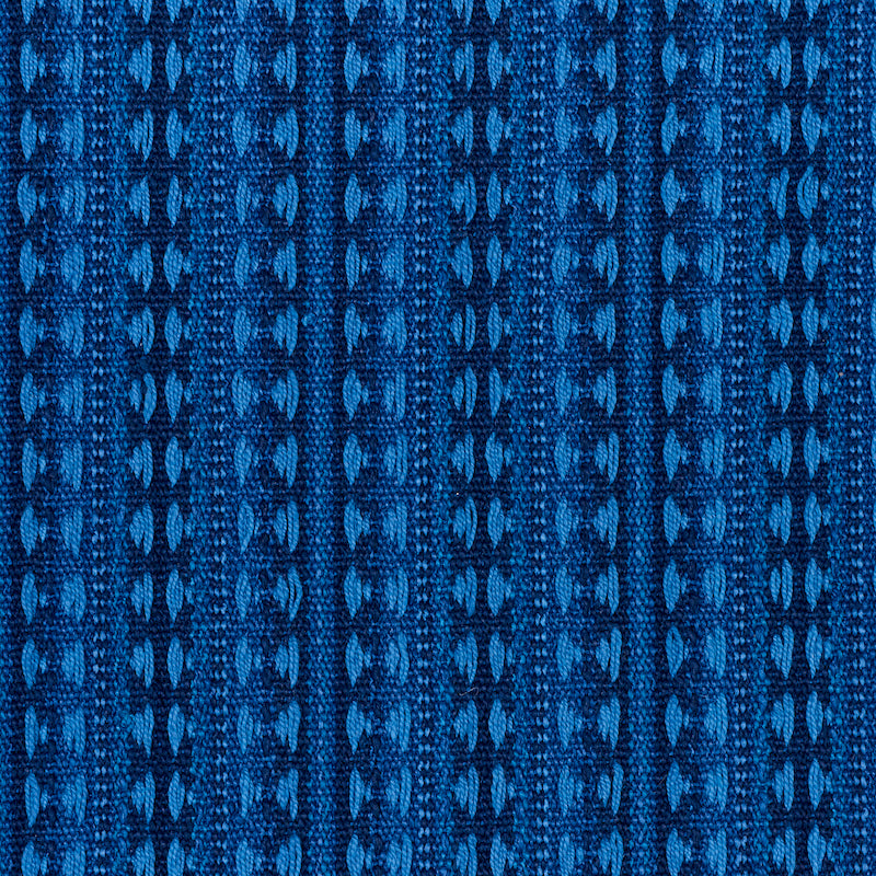 Blue jacquard knit fabric with vertical geometric stripes; textured blue textile for apparel or upholstery.