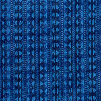 Blue jacquard knit fabric with vertical geometric stripes; textured blue textile for apparel or upholstery.