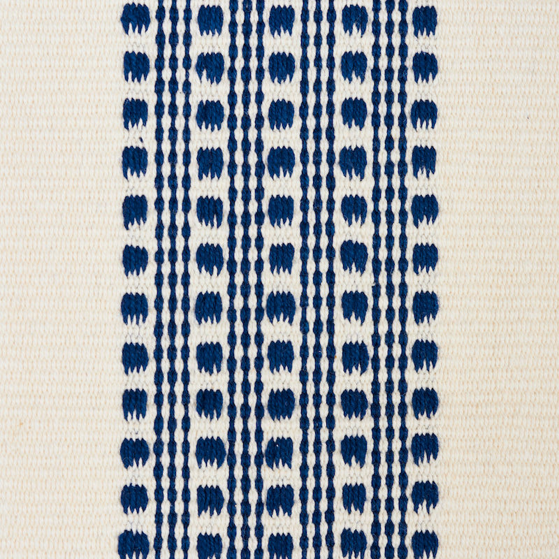 Beige textile with navy vertical dotted stripes formed by repeating oval shapes.