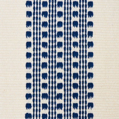Beige textile with navy vertical dotted stripes formed by repeating oval shapes.