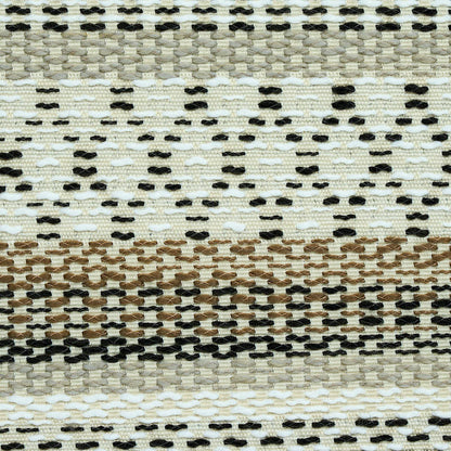 Handwoven jute rug with cream, tan and black dotted stripes in a geometric flat-weave design.