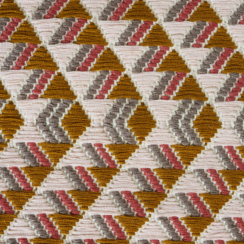 Geometric triangular woven textile in mustard, pink, gray and ivory; hand-woven brocade-patterned textile.