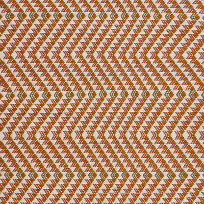 Woven fabric with a repeating chevron/diamond triangle pattern in brown, orange, and cream.