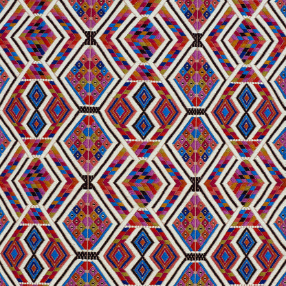 Vibrant geometric diamond lattice textile pattern in red, purple, blue, yellow with white stripes.