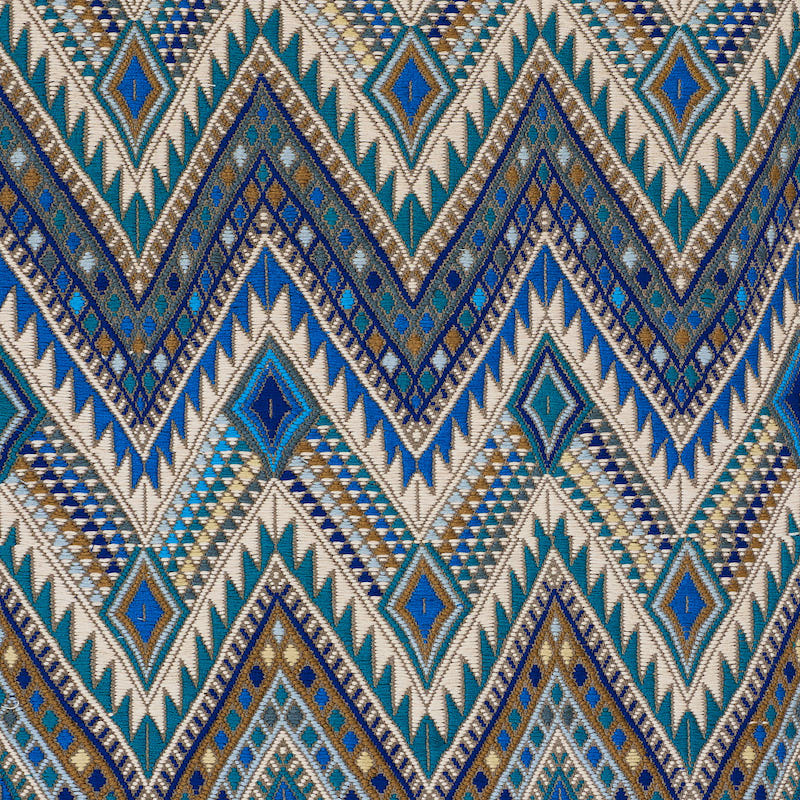 Boho geometric chevron and diamond woven fabric in teal, blue, gold, white.