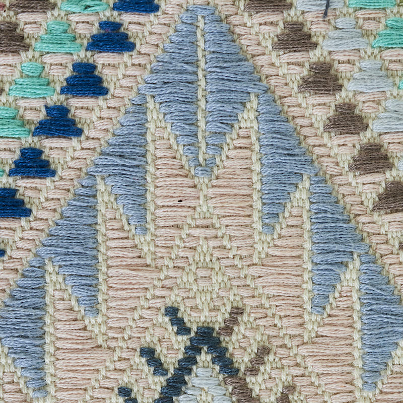 Geometric hand-woven brocade-pattern rug with diamond and triangle motifs in beige, blues and teals; cotton-wool blend.