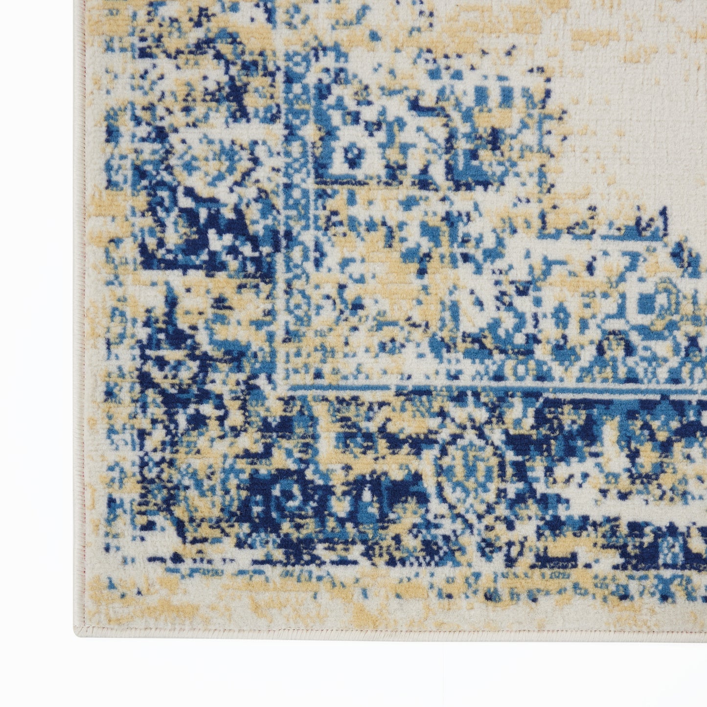 Rectangular rug with distressed blue and beige pattern and navy accents; woven floor covering with vintage-inspired design.