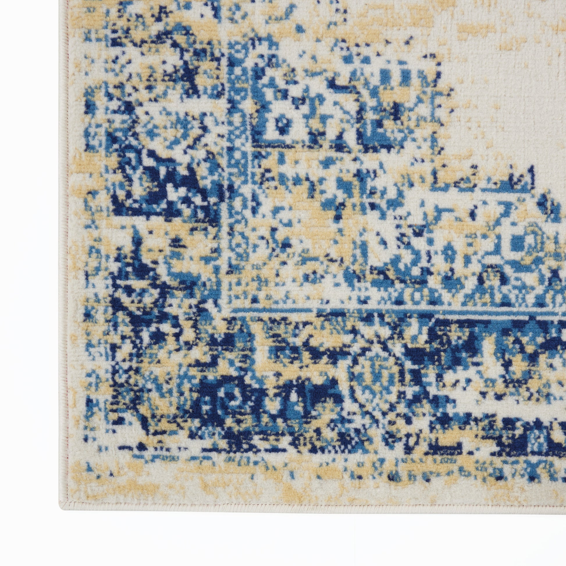 Rectangular rug with distressed blue and beige pattern and navy accents; woven floor covering with vintage-inspired design.