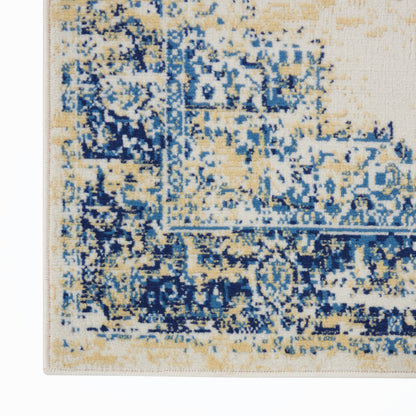 Rectangular rug with distressed blue and beige pattern and navy accents; woven floor covering with vintage-inspired design.