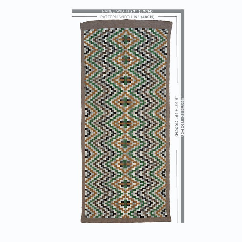 Long kilim-style runner rug with green, orange, brown and black diamond zigzag pattern on white, bordered in brown.