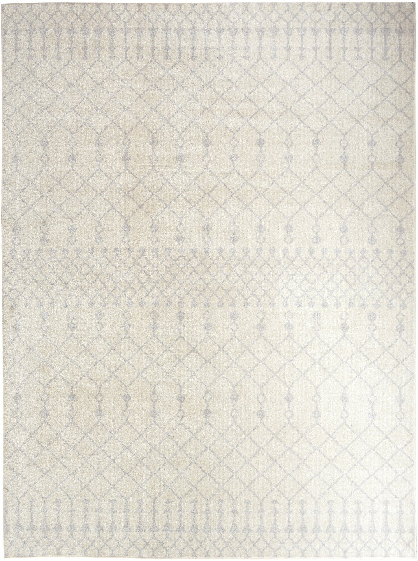 Cream ivory rug with subtle geometric diamond lattice pattern and rows of small ovals; neutral living-room decor.