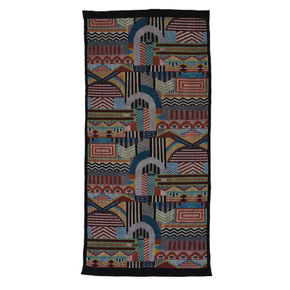 Long rectangular hand-woven brocade-pattern scarf with bold geometric designs in red, blue, teal, orange, yellow and a black border.