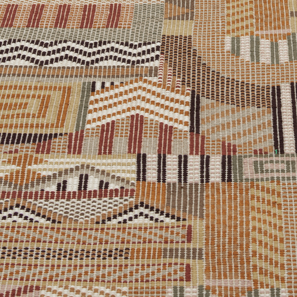 Warm earthy geometric rug with zigzags, chevrons and diamonds in orange, beige, brown, rust and cream; handwoven texture.