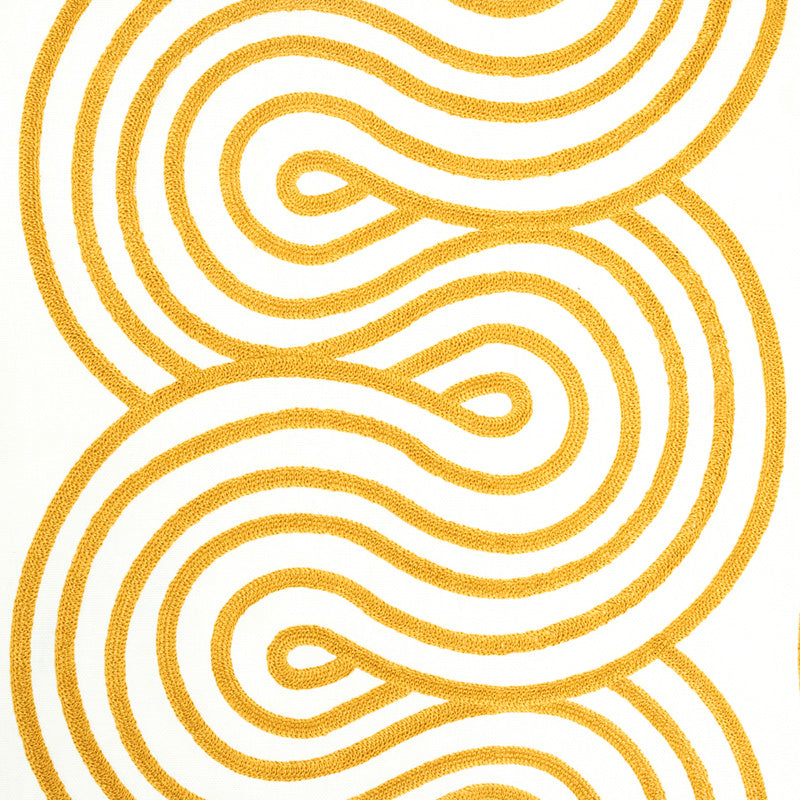 Mustard yellow looping abstract embroidery on white textile.