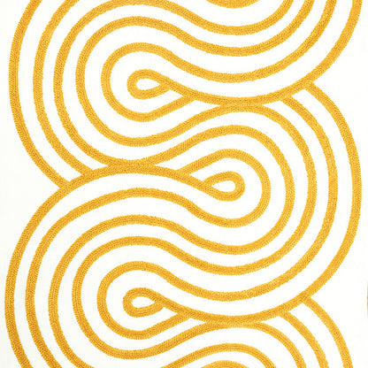 Mustard yellow looping abstract embroidery on white textile.